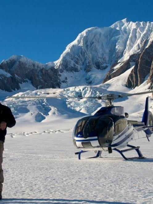Minister of Conservation Kate Wilkinson talks to pilot Giles de Garnham, of Glacier Helicopters,...