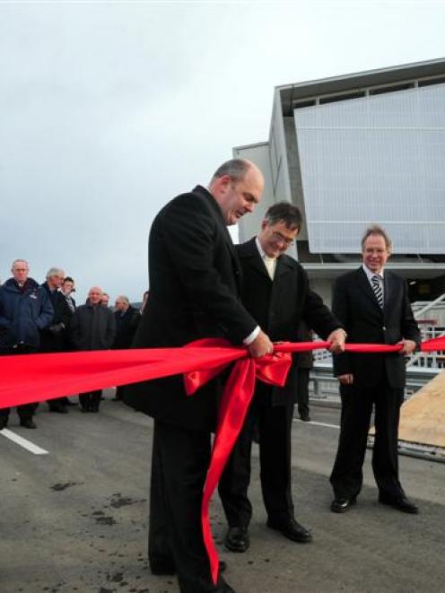 Minister of Transport Steven Joyce (left) cuts the ribbon to officially open the new section of...