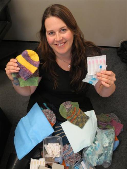 Miss Mathieson is pictured yesterday with some of the donated items. Photo by Tracey Roxburgh.