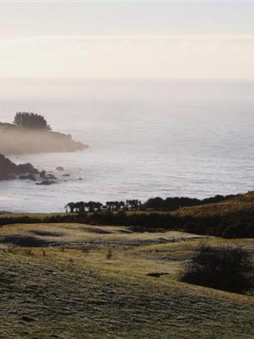 Mist rises over the coast between Warrington and Karitane, north of Dunedin. Photo by Getty Images.