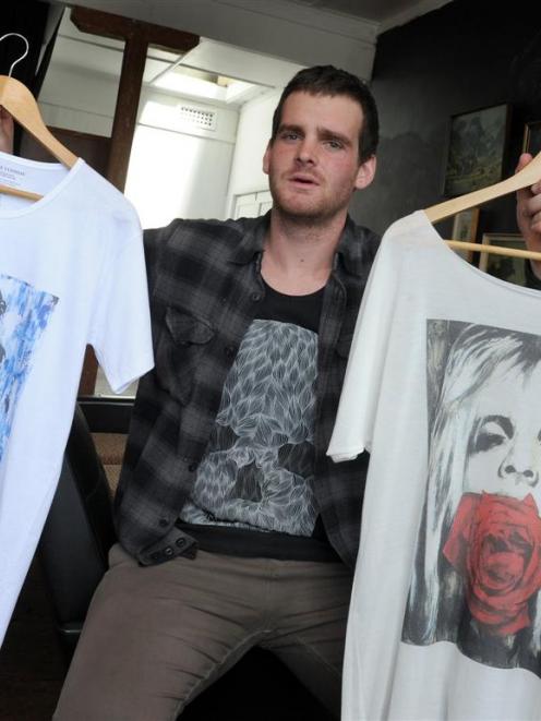 Moodie Tuesday creative director Jon Thom with some of his designer T-shirts. Photo by Craig Baxter.
