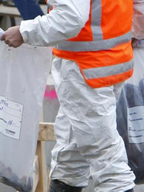 More items are removed in bags as Police continue to drill deeper into the hole in the search for...