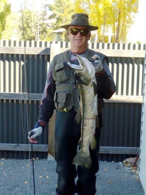 Mosgiel man Ian Marsh with the 94cm male brown trout he caught at Lake Aviemore. Photo supplied.