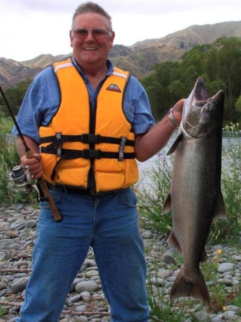 Mosgiel man Merv Dickison proudly shows off the nearly 16kg  salmon he caught in the Waitaki...