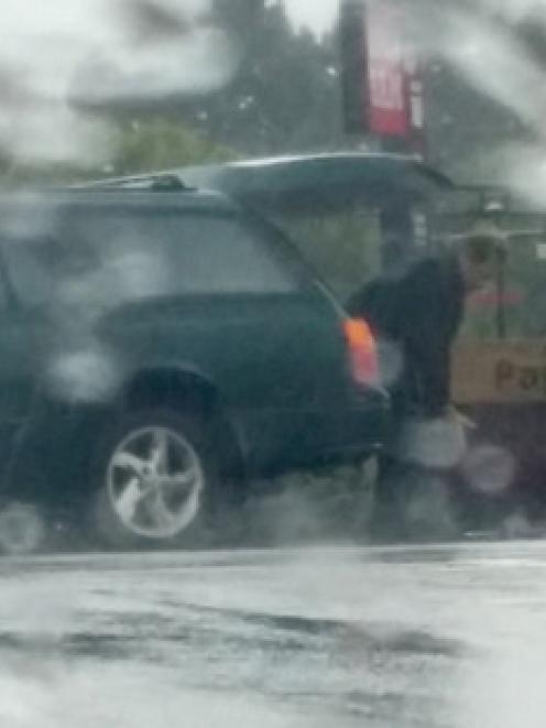 Motorists and nearby workers saw the corpse lying on the road in the rain at the intersection of...