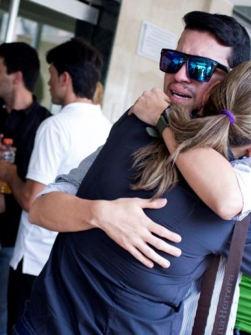 Mourners embrace during the wake for Genesis Carmona, who was shot during a protest earlier this...