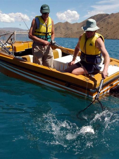 Murray Duffy (left)and Neville Henderson wear their life jackets as they fish on Lake Benmore in...