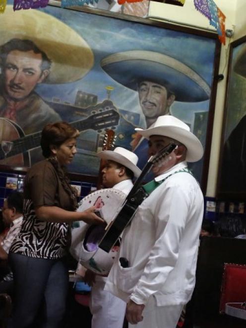 Musicians wait for customers at Tenampa bar in Mexico City's Plaza Garibaldi, the area where ...