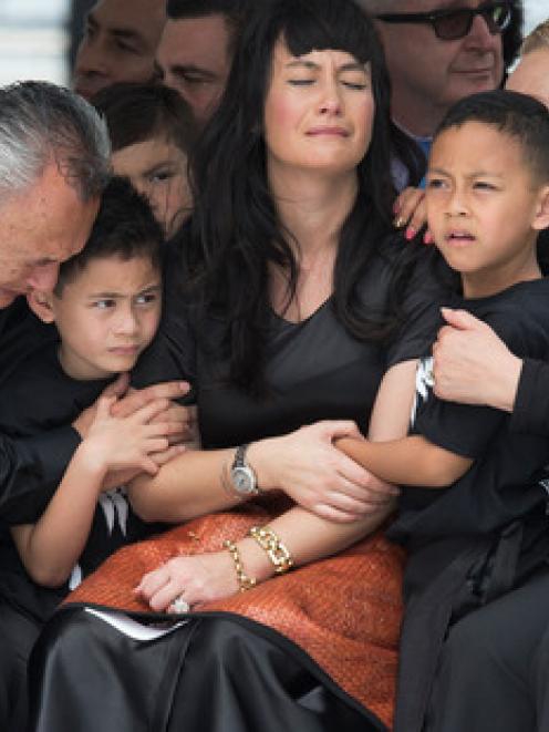 Nadene Lomu is comforted by family members during the public memorial for her husband, Jonah, at...