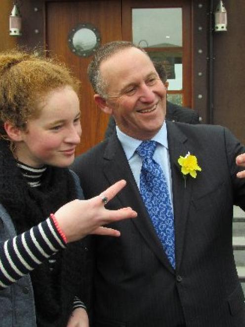 Nadia Kerr (16), of Oamaru, teaches Prime Minister John Key a ''Westside'' gesture. PHOTO: David...