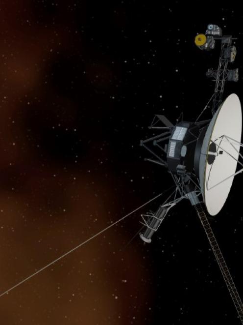 NASA's Voyager 1 spacecraft is shown entering interstellar space, or the space between stars, in...