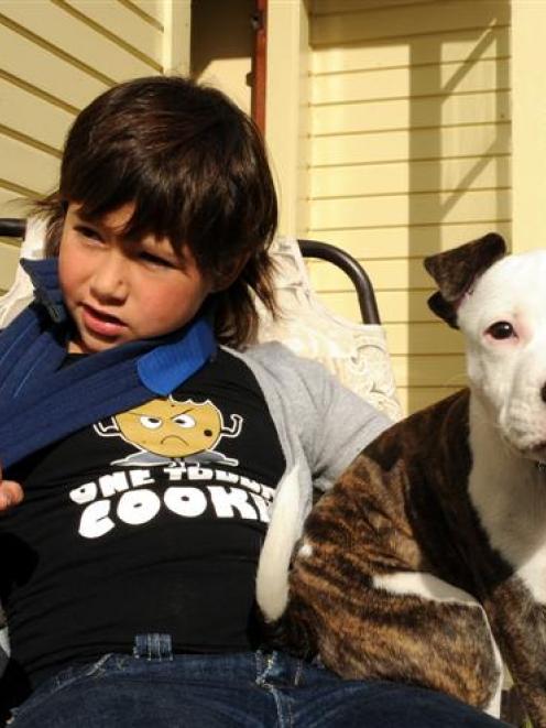 Natasha Iti recovers at home in Dunedin yesterday, with the help of pet dog Jackson, after she...