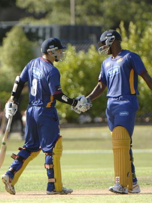 Nathan McCullum (left) is congratulated by Dimitri Mascarenhas after reaching his 50 at the...