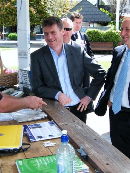 National Party leader John Key and deputy leader Bill English talk with Blair Payne, of...