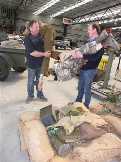 National Transport and Toy Museum staff member Bevan Duke (left) and curator Jason Rhodes move...