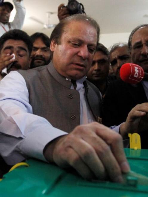 Nawaz Sharif, leader of the Pakistan Muslim League - Nawaz (PML-N) political party, casts his...