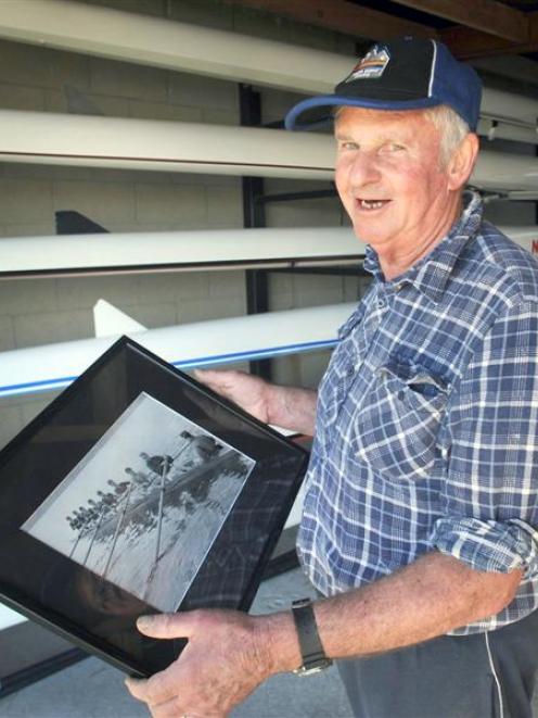 Neil Burrow holds a photo of the King Edward Technical College eight that finished third at the...