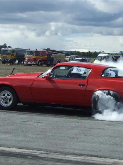 Neil Robertson, of Oamaru, revs up at the Blossom Festival Drags held on the runway at Alexandra...