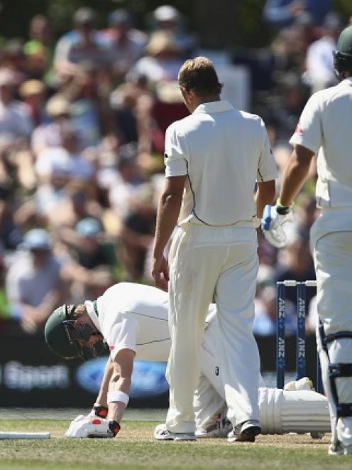 Neil Wagner (C) checks on Australia's Steve Smith after hitting him on the helmet with a short...