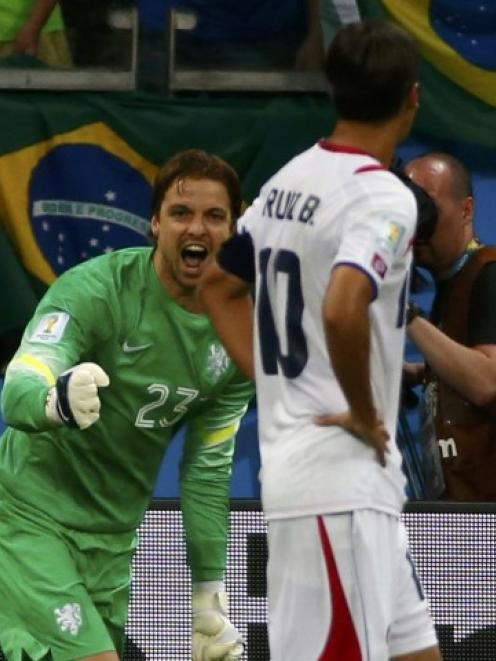 Netherlands goalkeeper Tim Krul (L) celebrates after he saved a penalty shot by Costa Rica's...