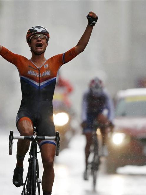 Netherlands' Marianne Vos reacts as she crosses the finish line ahead of Britain's Elizabeth...