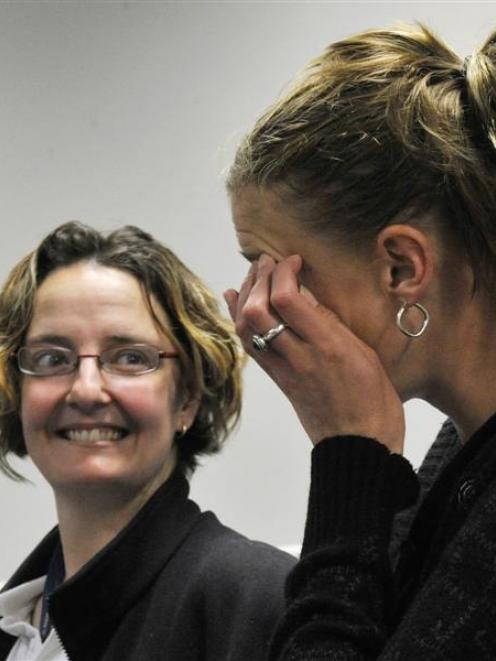 Neurosurgery survivor Nicki Fairbairn (left) supports fellow survivor Casey Coombes as she wipes...