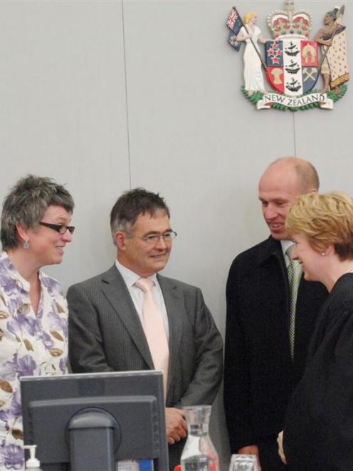 New JPs (from left) Laura Black, Dave Cull and Gary Johnson listen to Judge Mary O'Dwyer...