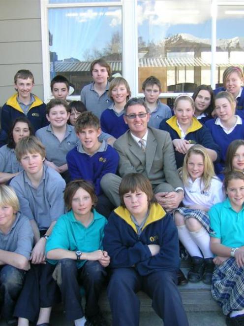 New Mt Aspiring College principal Wayne Bosley is surrounded by pupils in year 8FA yesterday....