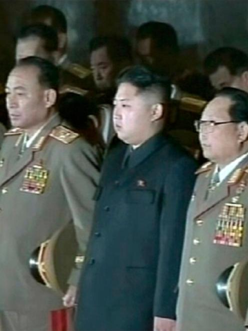 New North Korean leader Kim Jong-un (centre) stands among a row of top military officers,...