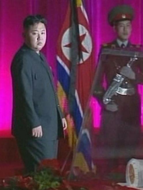 New North Korean ruler Kim Jong-un (centre) pays his respects to his father and former leader Kim...