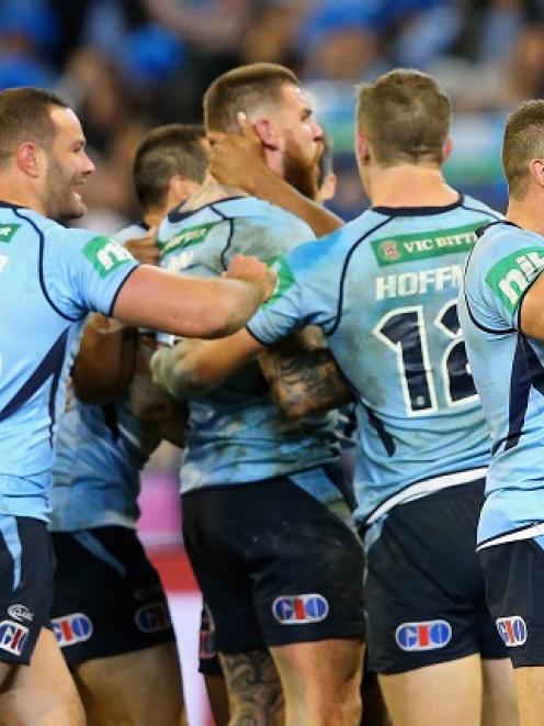 New South Wales players celebrate Josh Dugan's try against Queensland. Photo Getty