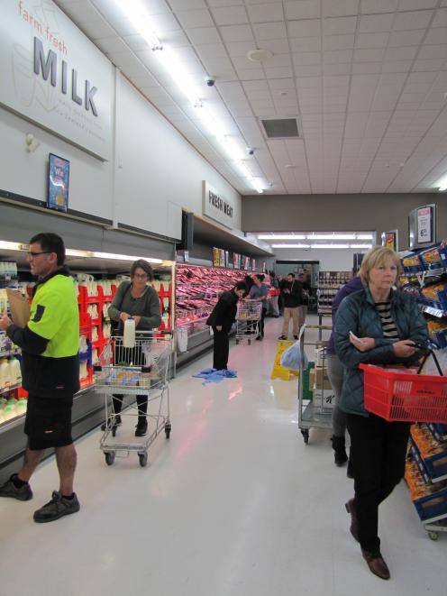 New World Supermarket staff in Wanaka mop up spilt milk after today's earthquake. Photo by Mark...