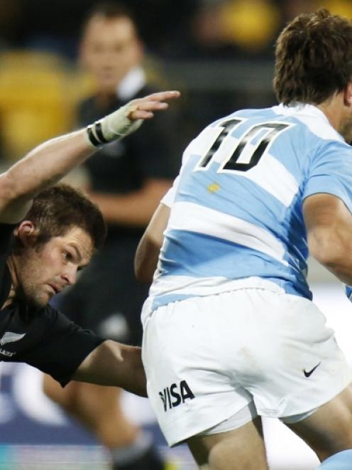 New Zealand All Blacks' captain Richie McCaw (left) tackles Argentina Pumas' Juan Martin...