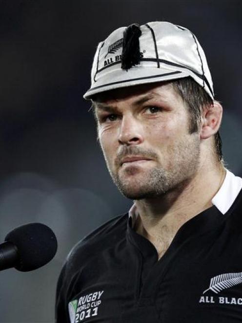 New Zealand All Blacks captain Richie McCaw reacts after receiving his 100th test cap at the end...