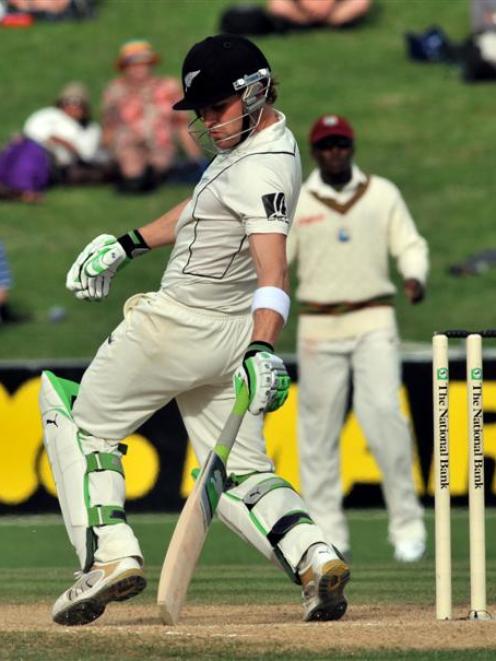 New Zealand batsman Brendon McCullum swings and apparently misses, although judged out by a...