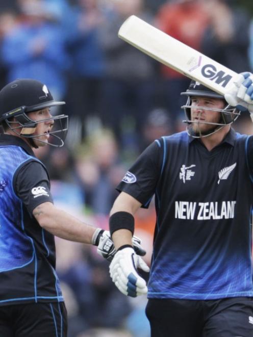 New Zealand batsman Corey Anderson (right) celebrates his 50 runs alongside teammate Luke Ronchi...