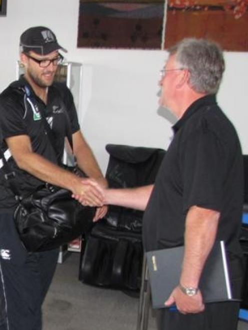 New Zealand captain Daniel Vettori  is greeted by Queenstown liaison manager Ian Paterson as the...