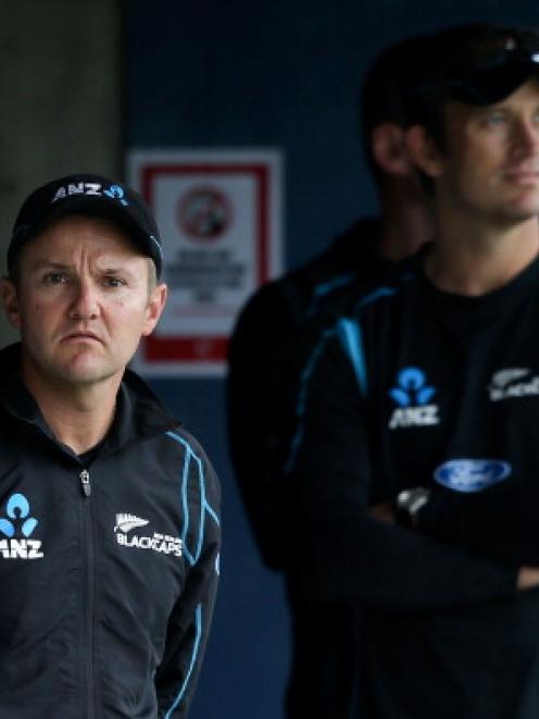 New Zealand coach Mike Hesson and bowling coach Shane Bond wait for the rain to stop in Napier.  ...