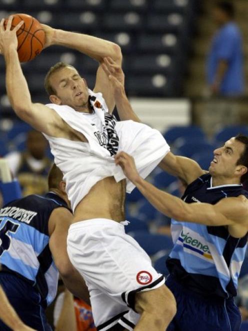 New Zealand forward Sean Marks grabs a rebound over Argentina guard Manu Ginobili during the...