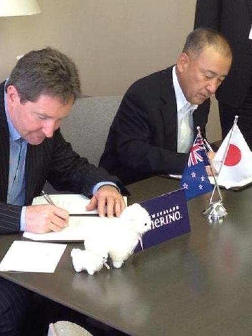 New Zealand Merino Company chief executive John Brakenridge signs a deal with Japanese company...