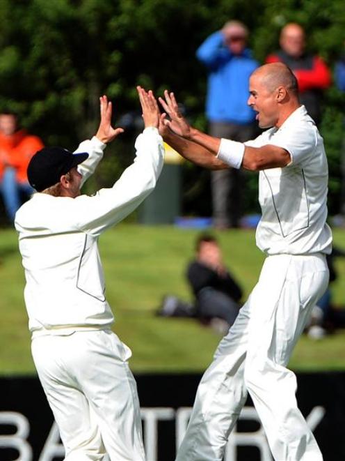 New Zealand paceman Chris Martin (right) celebrates with team-mate Kane Williamson after taking...