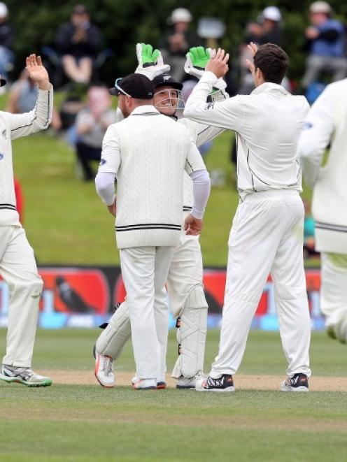 New Zealand players celebrate after taking a wicket as they closed in on victory against Sri...