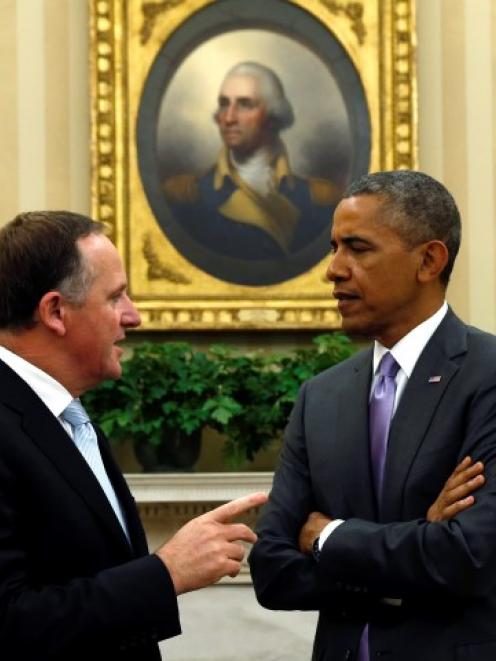 New Zealand Prime Minister John Key (L) speaks with US President Barack Obama in the Oval Office...