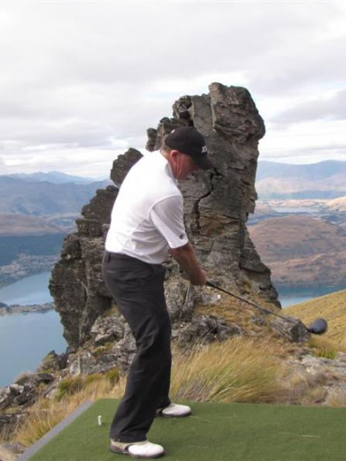 New Zealand Prime Minister John Key tees off at a novelty par 3 golf hole on Cecil Peak on...