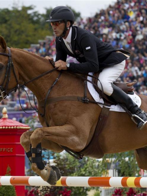 New Zealand's Andrew Nicholson clears a fence during the show jumping. New Zealand Herald/Brett...