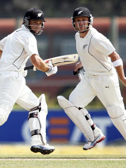 New Zealand's Brendon McCullum and Daniel Flynn run between wickets during their partnership of...