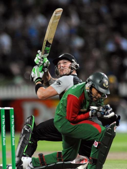 New Zealand's Brendon McCullum hooks the ball over the head of Bangladesh's Mushfiqur Rahim for 4...