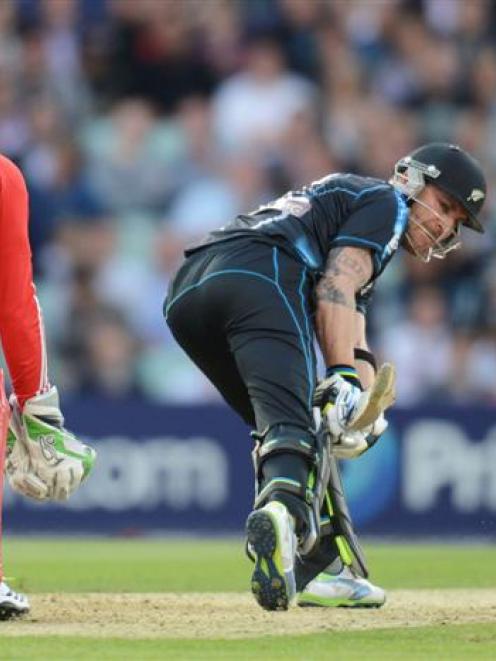 New Zealand's Brendon McCullum plays a shot as England's Jos Buttler (left) looks on. REUTERS...