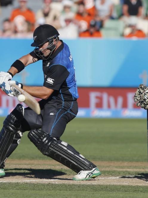 New Zealand's Cory Anderson plays a shot watched by Afghanistan's Afsar Zaza (R) during their...