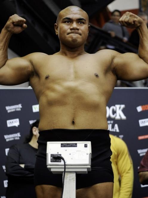 New Zealand's David Tua stands on the scales at the official weigh-in for the heavyweight bout...